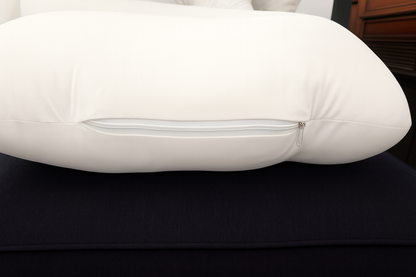 White HerPillow U-shaped pillow on a dark surface 