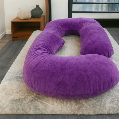 HerPillow® purple U-shaped full-body pillow displayed on a bed in a modern bedroom.